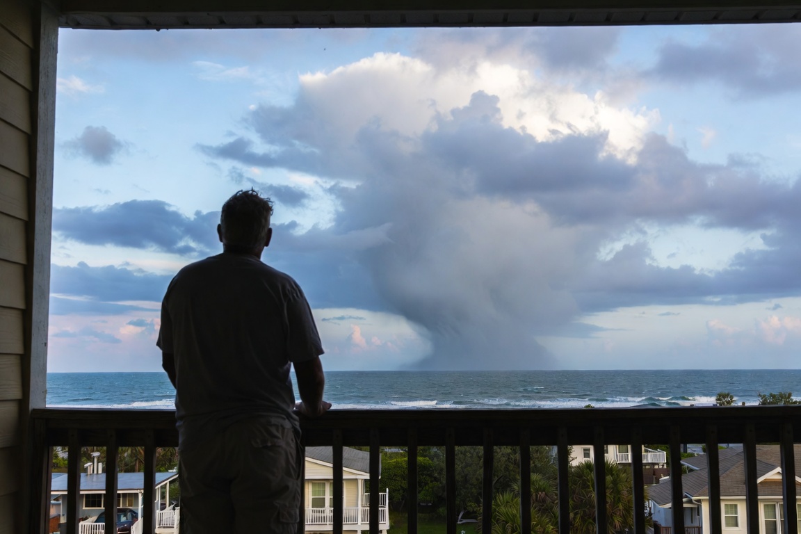 A homeowner staring off the coast of Florida into a hurricane approaching